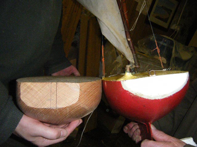 Stephen and Loughie compare the size and shape of the sterns of the new hull and Loughie's boat. Photo: Brian Teggart